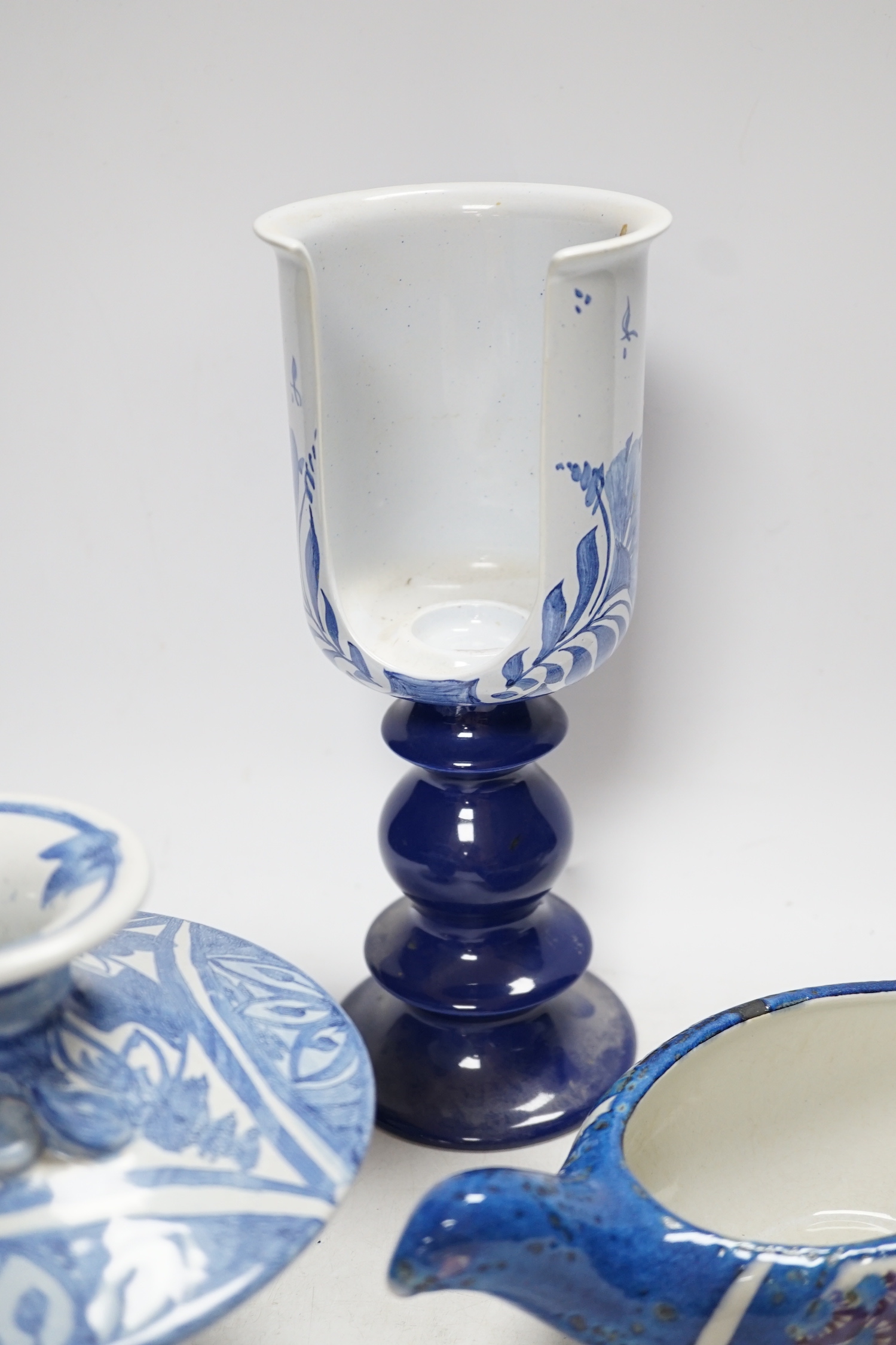 Two Danish ceramic items designed by Bjorn Wiinblad; a lidded pedestal cup in the form of a head with large hat and a candlestick, 26cm high, together with a bird sauce boat signed BJ on base (Berte Jesson)